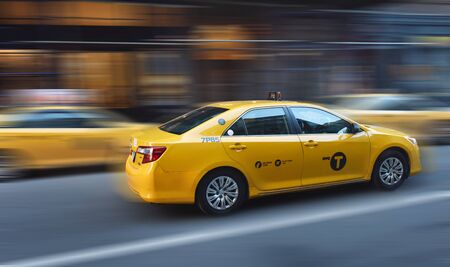 New York Taxi Moving faster in New York City at the street of Manhattan. Yellow cab fast in a day lightのeditorial素材