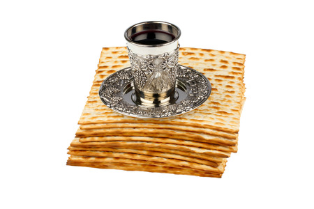 passover matzo with kiddush cup of wine isolated on white backgroundの写真