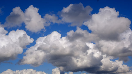 Blue sky background with white clouds.