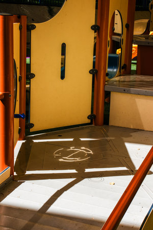 Playground interior with sunlight and abstract shadows.