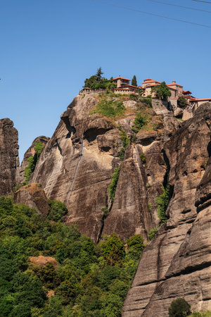 Meteora, Greece - May 03, 2024: Meteora Monastery on Cliff in Greece with Mountain Landscape.