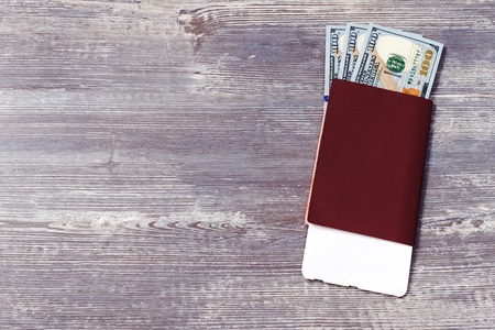 Red passport with money and boarding pass for travel concept.の写真素材
