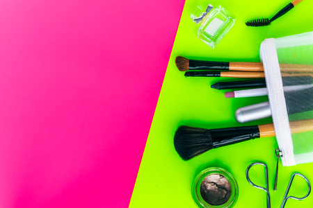 Makeup And cosmetics set on yellow and pink background top view with space for text.の写真素材