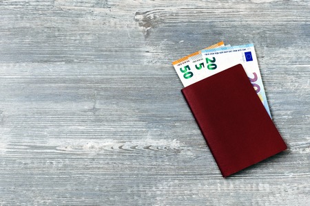 Red passport with euro money with copy space. travel concept.の写真素材