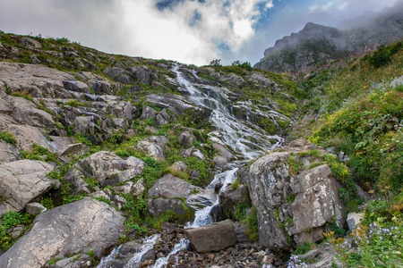 Caucasus mountain waterfall on rock mountain in the green rocky mountainside. Mountain landscape.の写真素材