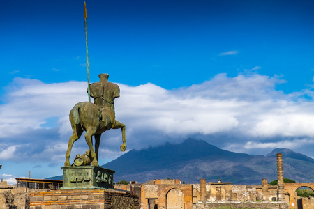 Mount Vesuvius and ancient statue in ruins of town Pompeii in Italyの写真素材