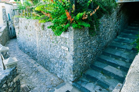ancient road sign on corner in Ravello, indicating the direction to Amalfi. In the province of Salerno, on the Amalfi coast.の写真素材