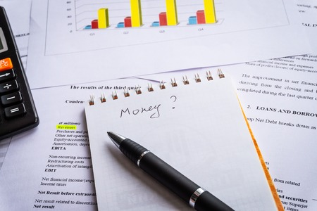 Pen, calculator On the financial account documents. Financial statement concept.の写真素材