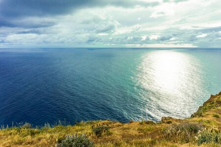 Rocky coast of the Atlantic ocean at Madeira archipelago in Portugal at sunsetの写真素材