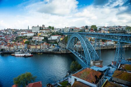 Oporto or Porto city skyline, Douro river, traditional boats and Dom Luis or Luiz iron bridge. Portugal, Europe.の写真素材