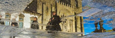 Reflection of the catholic church in puddle in Porto, Portugal. Wide bannerの写真素材