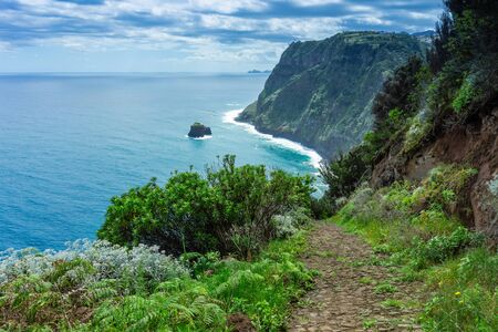 Mountains and ocean with waves on northern Atlantic coast of Madeira, Portugalの写真素材
