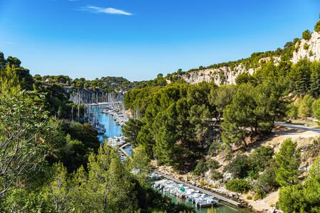 White sailing yacht in the sea fjord. National park of Calanques in Provence. The picturesque gulf with turquoise water at coast of the Mediterranean Seaの写真素材