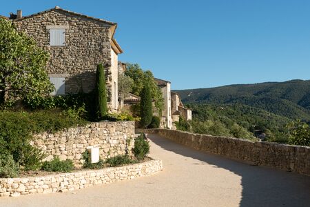 Sunny street and historical buildings in the old town of Menerbes, Provence-Alpes-Cote d'Azur, Franceの写真素材