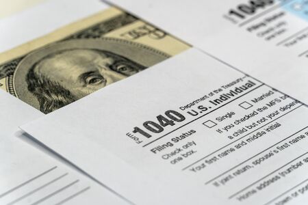 Tax form with pen and dollar banknote. document are mock-upの写真素材
