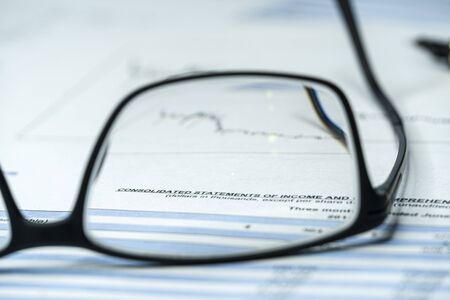Income statement financial report through glasses. Investment analysis in financial crisis time....
