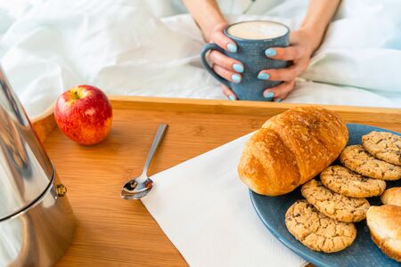 Happy attractive woman wake up in the morning in bed. Good morning and fresh and beautiful breakfast on tray for the girlの写真素材