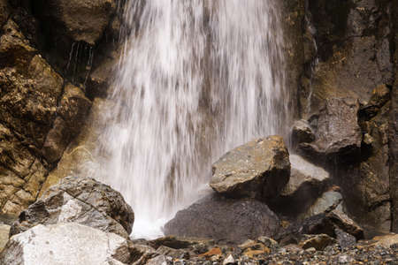 Water falling on the rocks in close up. Long exposure shot