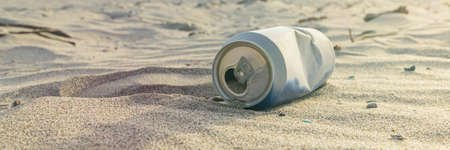 Empty alcohol cans on a desert, beach.