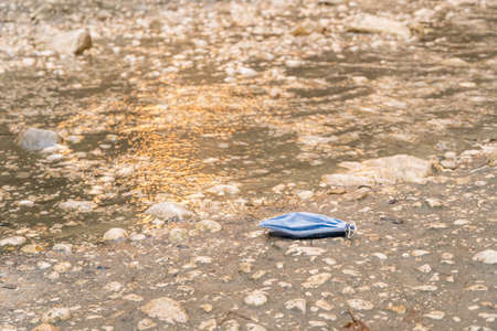 Used medical mask in Canyon Saklikent in Turkey. Garbage polluting the natural environmentの写真素材