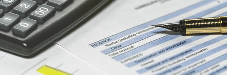Accounting business and financial report with pen and calculator. Income statement form analysis, Selective focusの写真素材