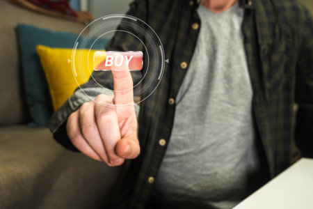 Man hand push on virtual button buy. Online shopping or e-commerce. Man spending money from home.の写真素材