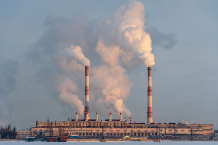Air pollution by smoke coming out of the factory chimneys in the industrial zone. Global warming...