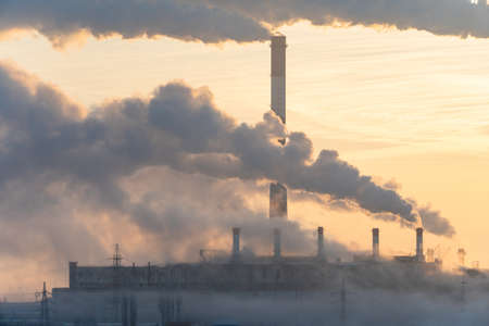 Environmental problem of pollution of environment and air in cities. Smoking industrial zone factory chimneys. View of large plant with Smoking pipesの写真素材