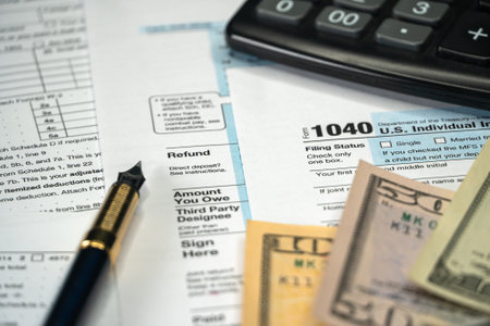 Blank Form 1040 U.S. Individual Income Tax Return with Pen and banknotesの写真素材