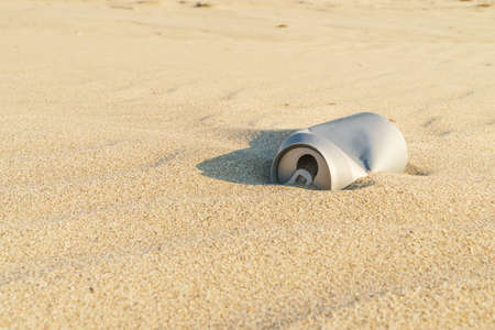 Old rusty beverage can in the sand desert. Pollution of nature recycle the trash. Environment Global problemの写真素材