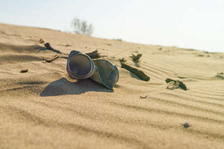 Old rusty beverage can in the sand desert. Pollution of nature recycle the trash. Environment Global problemの写真素材
