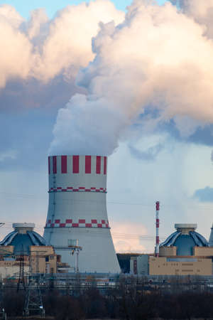 Nuclear power plant cooling towers emissions of steam in the air atmosphere. Industrial zone. Vertical photoの写真素材