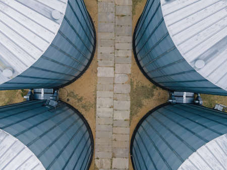 Aerial view of metal grain elevator in agricultural zoneの写真素材