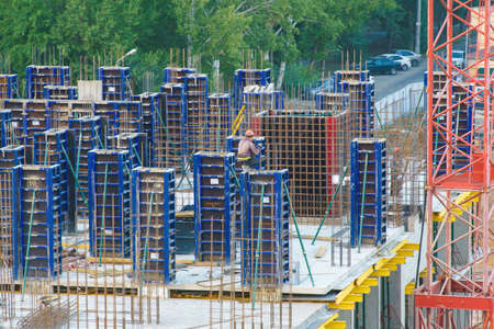 Worker pouring on a building construction site. Concrete mixture formworkの写真素材