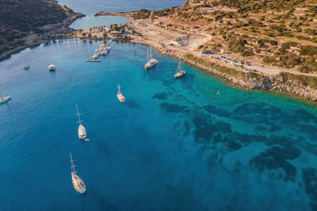 Yachts and sailing boatsin bay with a turquoise and transparent sea.の写真素材