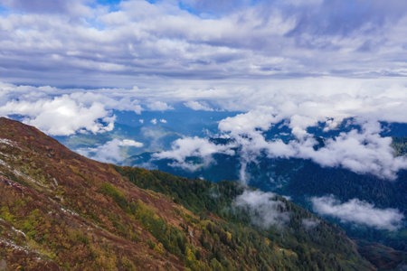 Aerial view above the clouds in mountain valley at morningの写真素材
