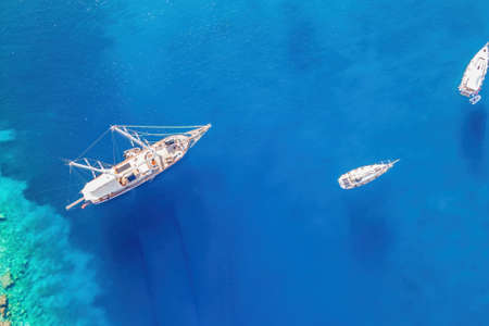 Sailing yachts anchored in the bay with clear and turquoise water. Aerial drone viewの写真素材