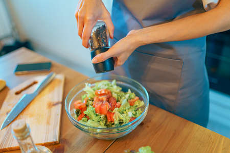 Woman preparing vegetable meal, Vegetarian cooking healthy food in modern kitchenの写真素材