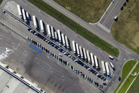 Parking of Large logistics park with warehouse, loading hub in industrial zone and technology park. Aerial viewの写真素材
