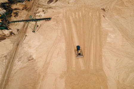 Buldozer machinery work in in opencast sand quarry. Aerial view of mining machinery. Mining industryの写真素材