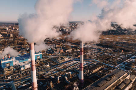Factory smokestack emissions, climate change and global warming for the environment concept. Aerial viewの写真素材