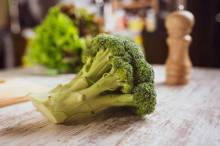 Woman cooking broccoli on the kitchen at home. Homemade food and eating healthy conceptの写真素材