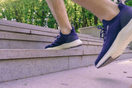 Man athlete legs running up stairs training intense cardio work out exercise, male runner feet...