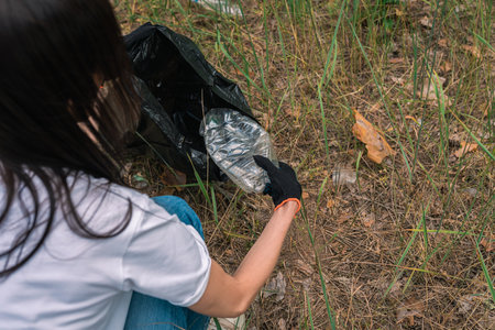 Female volunteer cleaning nature from trash. clean planet conceptの写真素材