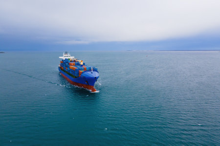 Container Cargo vessel underway on sea to port, aerial viewの写真素材