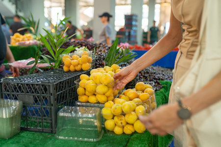 Woman buy ripe fruits at farmer marketの写真素材