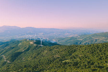 Aerial view of nature with eco-friendly wind turbines power plant in mountain at sunsetの写真素材
