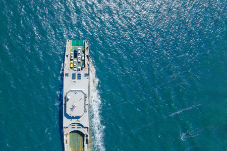 Ferry carrying cars and passengers across the sea, top down aerial drone view. Ferry transporting cars. air viewの写真素材