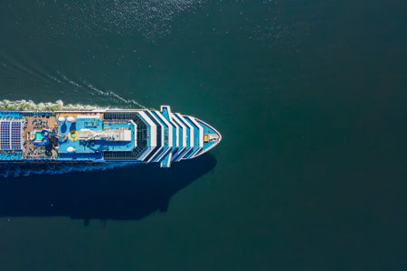 Cruise ship sailing across sea, top down aerial, white cruise liner in a sunny day. Luxury cruise in the ocean sea concept tourism travelの写真素材