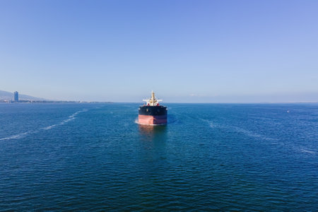 Aerial front view of Bulk cargo carrier ship for carrying dry cargo cruising across the seaの写真素材